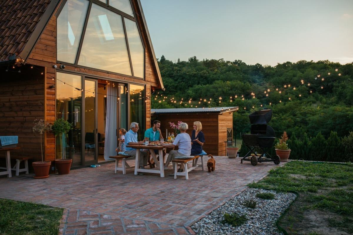 A family who is enjoying a cookout at their pet-friendly cabin in the mountains.