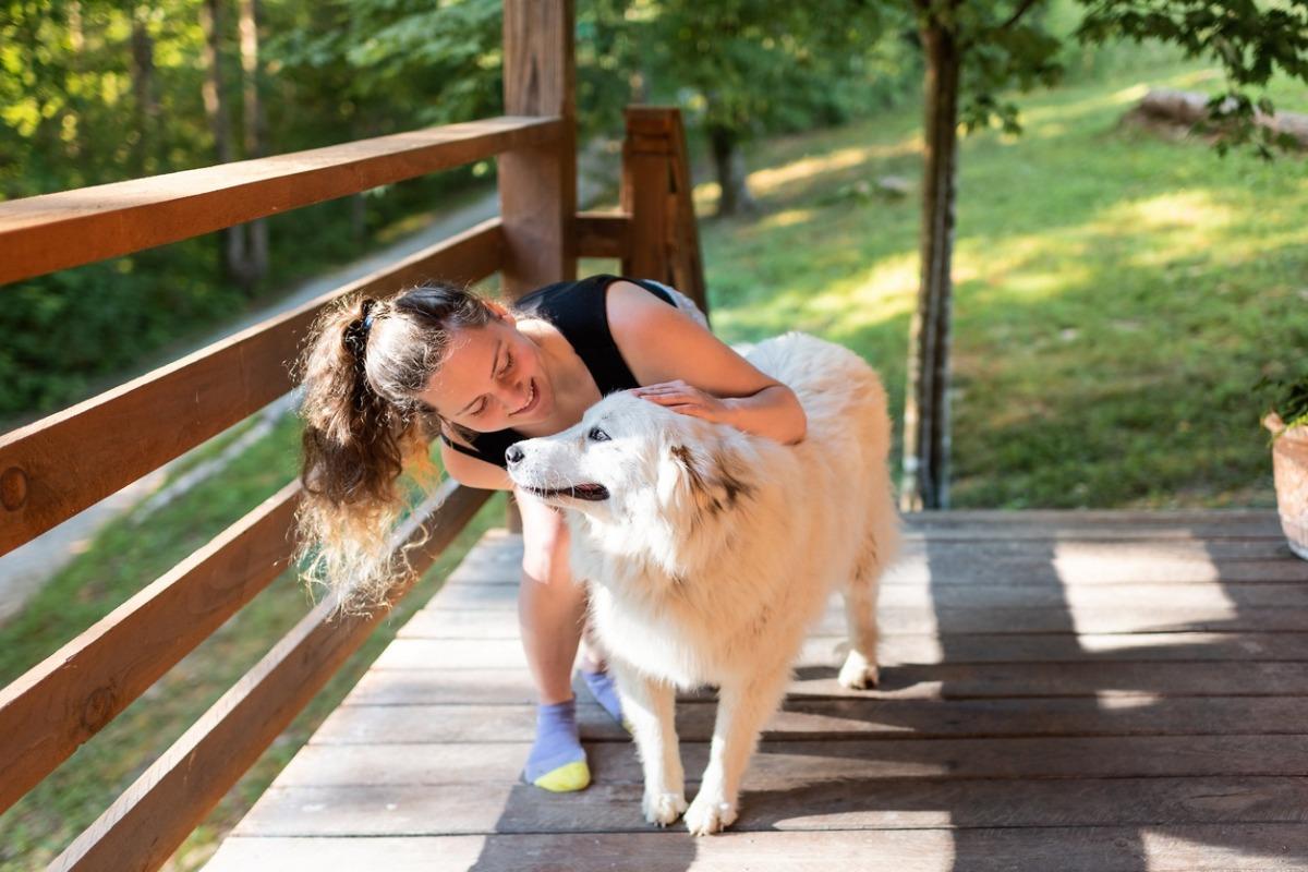 woman and her pet dog at a pet-friendly cabin in the mountains