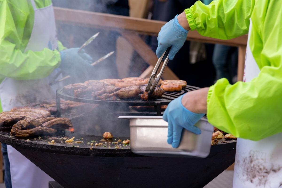 Grilling meat at an outdoor bbq festival