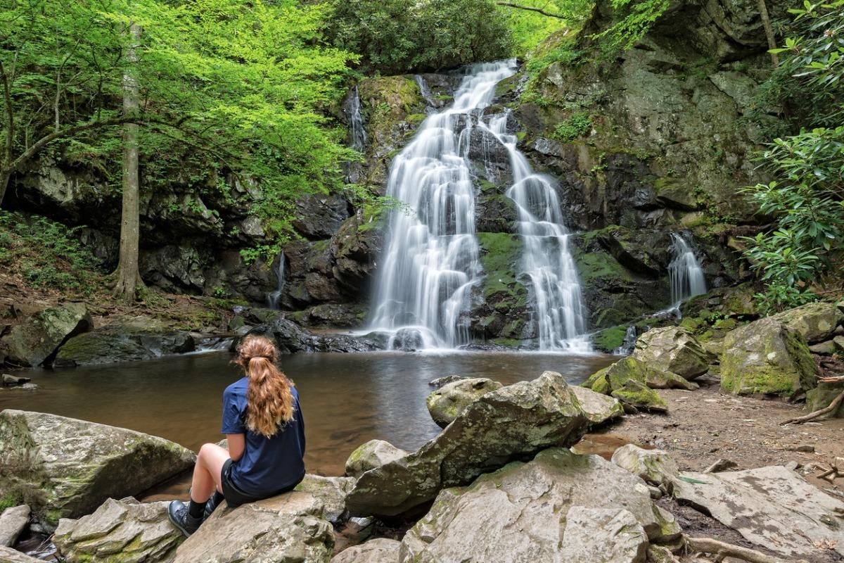 A woman who has hiked to a local waterfall in the Great Smoky Mountains.